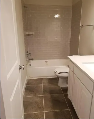 a bathroom with a toilet a sink and bathtub