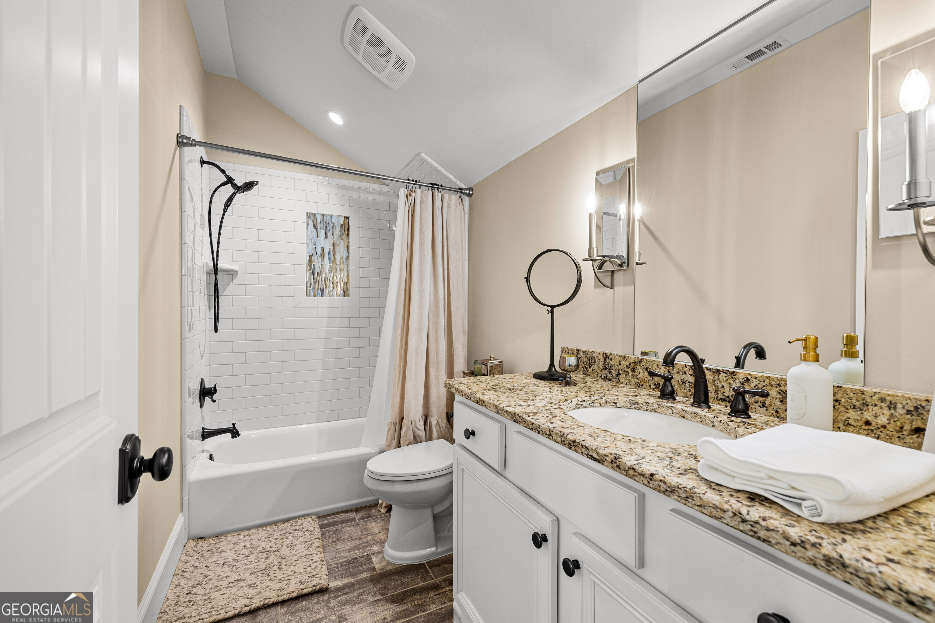 752 Grant Road Brooks, GA 30205 - Photo 66 of 132 a bathroom with a granite countertop sink a toilet a mirror a bathtub and shower