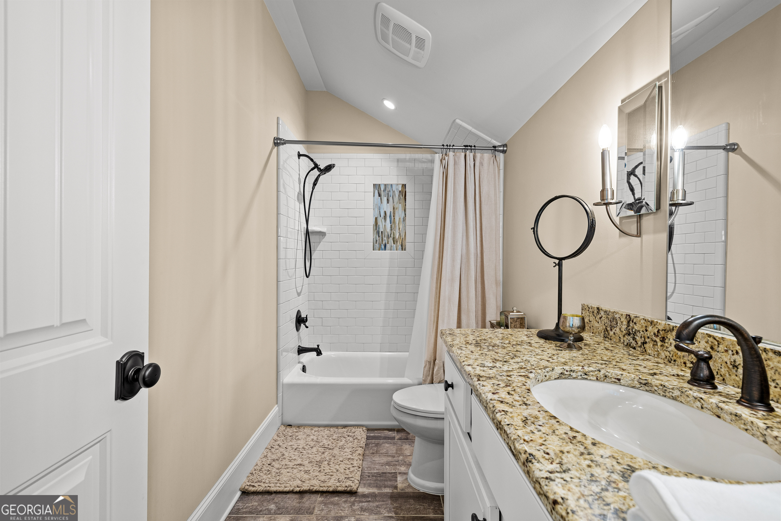 752 Grant Road Brooks, GA 30205 - Photo 67 of 132 a bathroom with a granite countertop sink a mirror a vanity and a shower