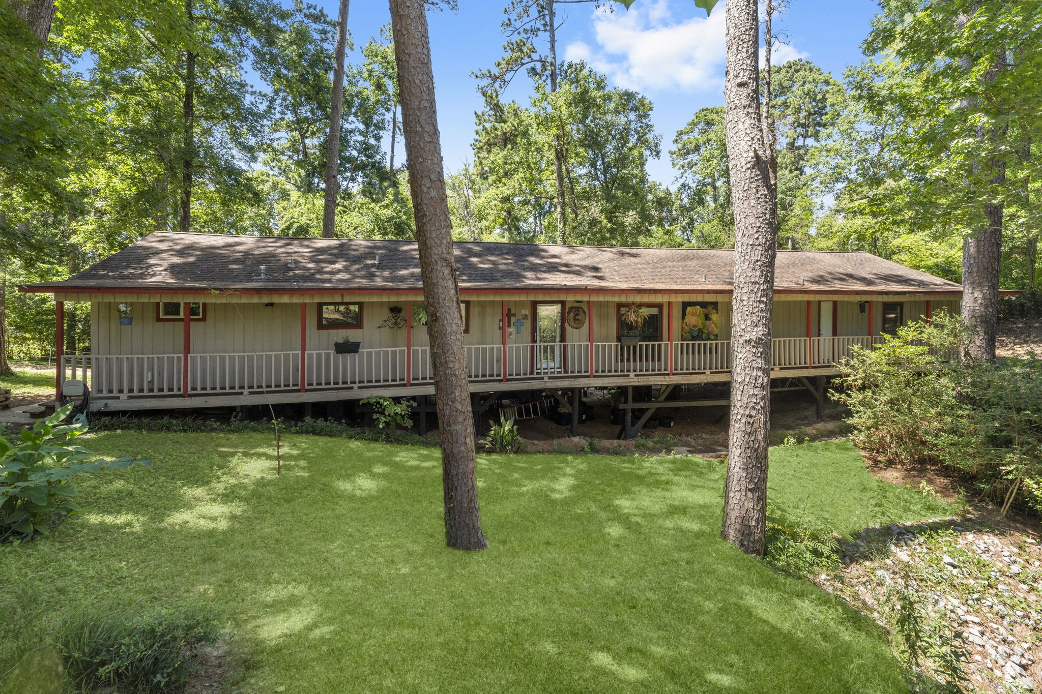 a view of a house with a backyard and a tree