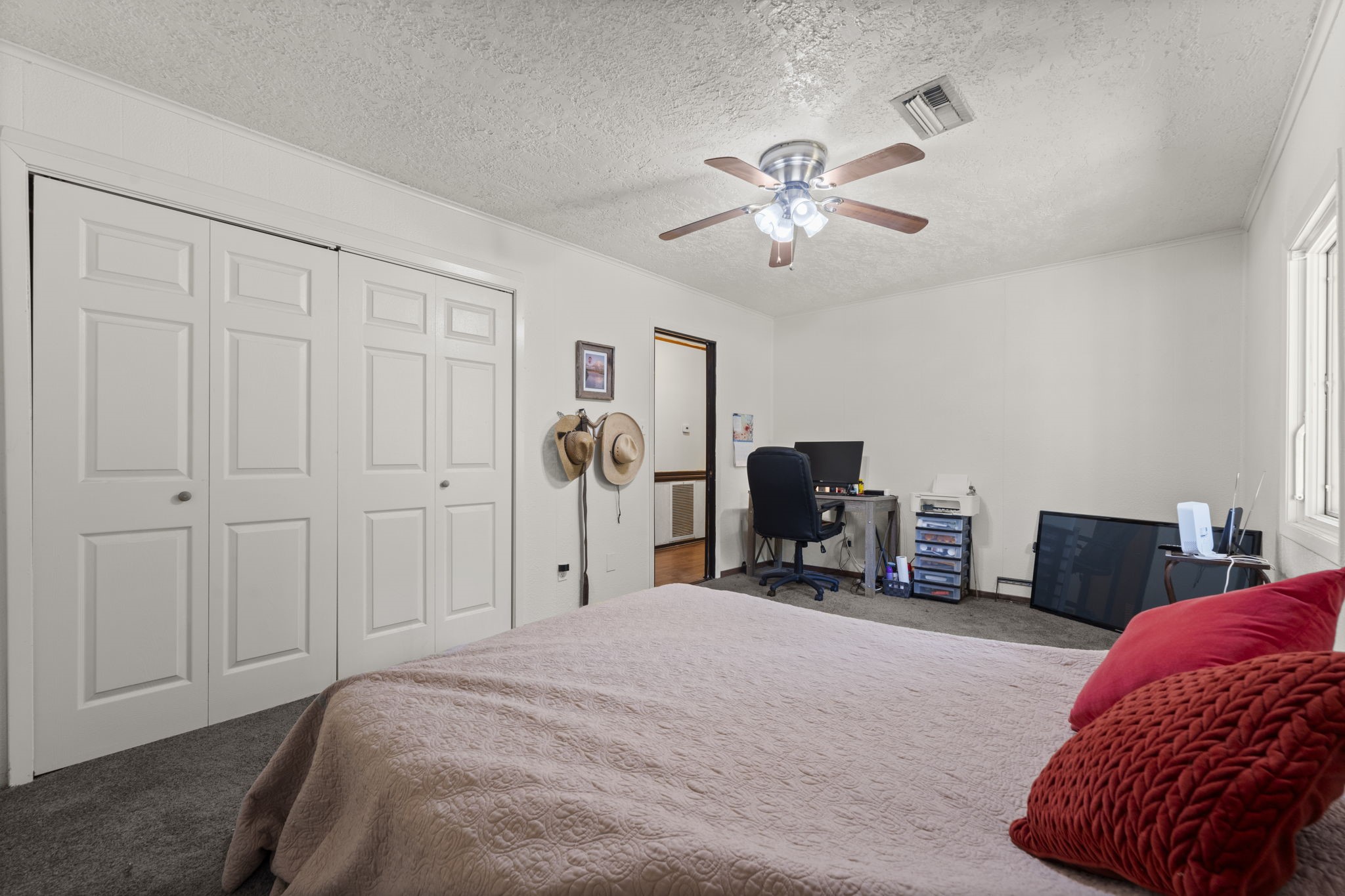 114 Hillendale Street Livingston, TX 77351 - Photo 35 of 46 a bedroom with a bed and a chandelier