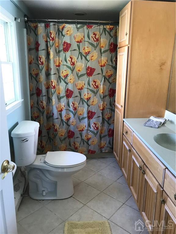 398 Ridge Road Dayton, NJ 08810 - Photo 6 of 19 a bathroom with a toilet sink and shower curtain