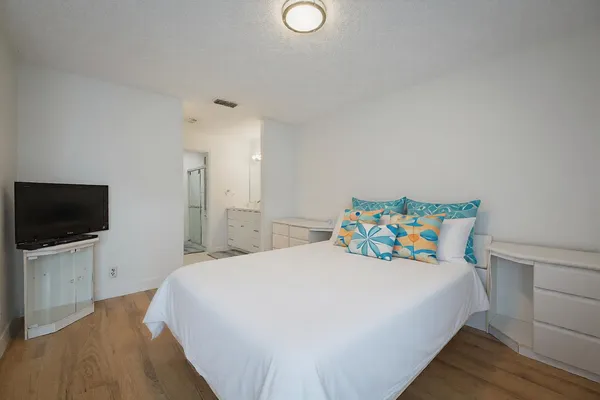 a bedroom with a bed and a flat screen tv