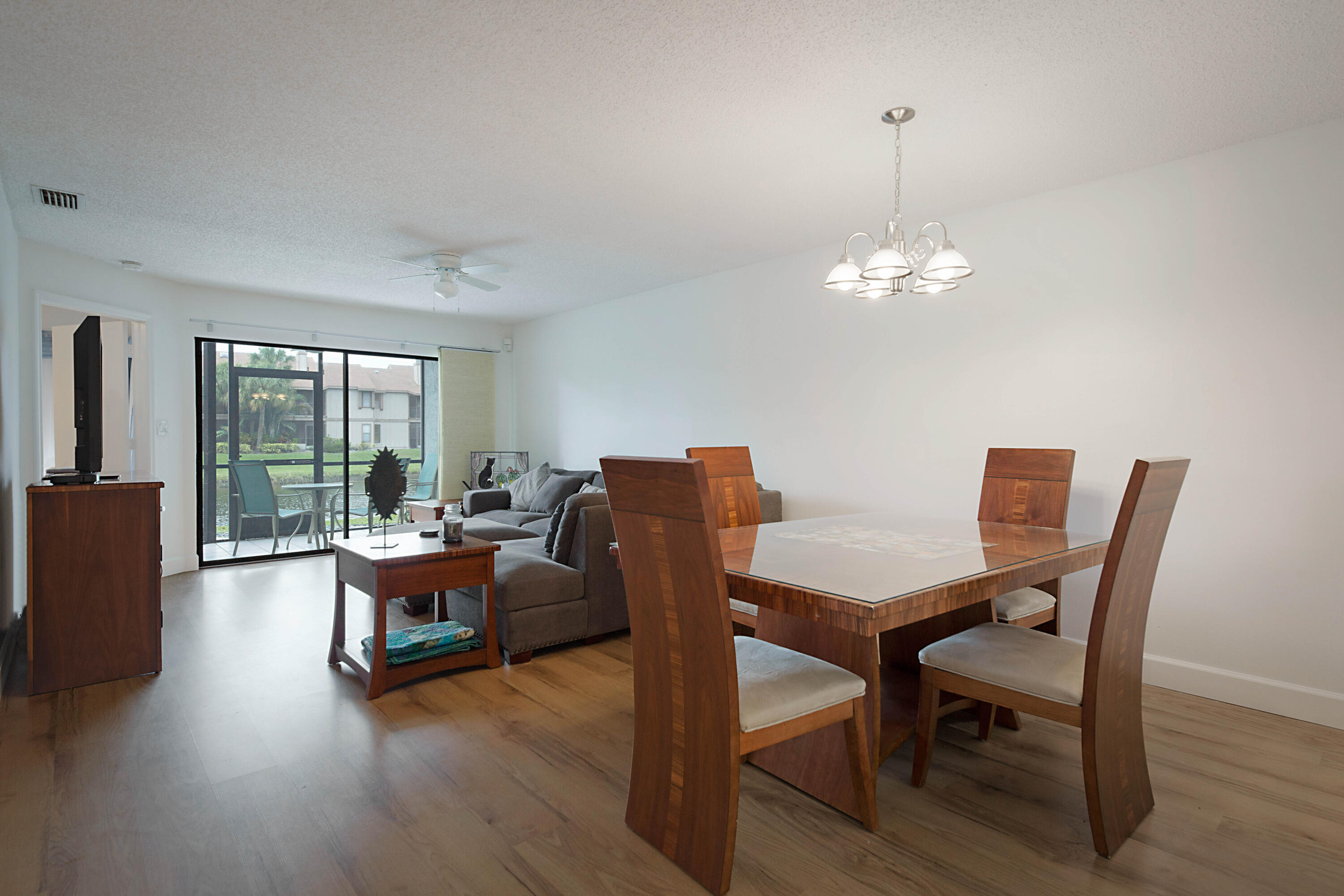 903 Harbour Pointe Way Greenacres, FL 33413 - Photo 7 of 26 a view of a dining room with furniture wooden floor and chandelier
