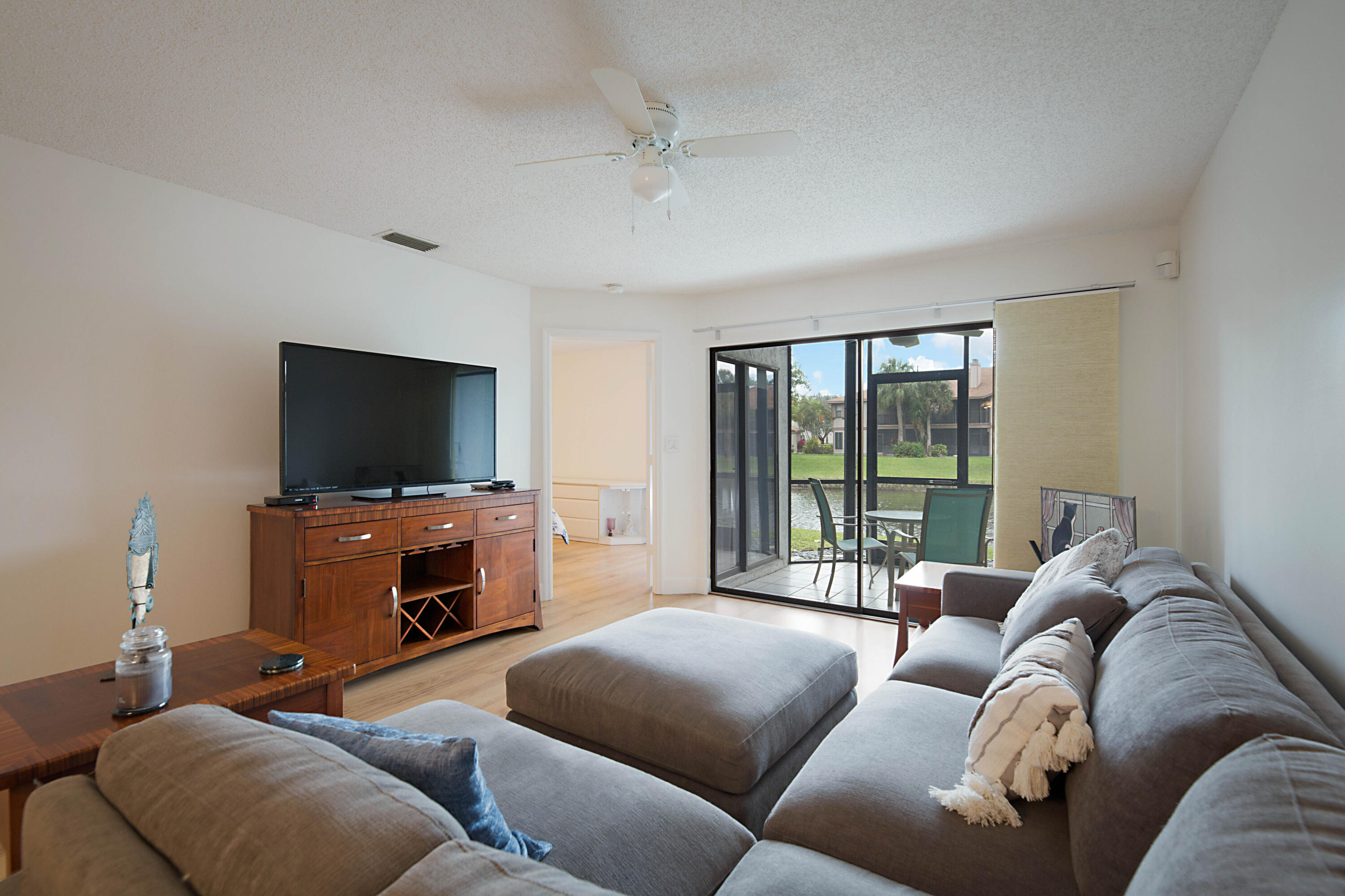 903 Harbour Pointe Way Greenacres, FL 33413 - Photo 9 of 26 a living room with furniture and a flat screen tv