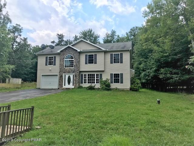 6305 Laurel Road Pocono Summit, PA 18346 - Photo 1 of 13 a view of a house with a yard