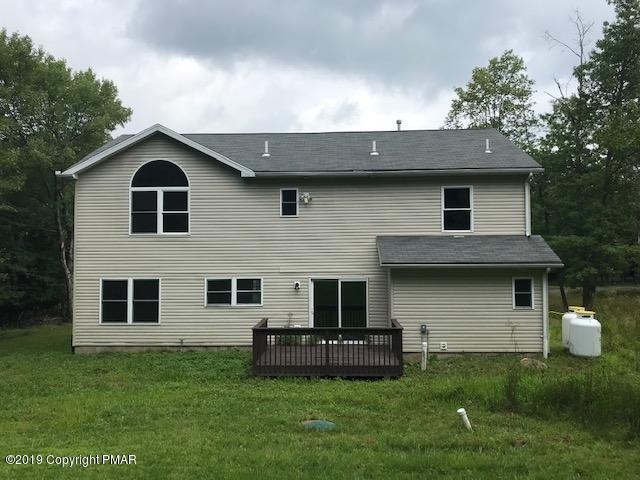 6305 Laurel Road Pocono Summit, PA 18346 - Photo 13 of 13 a front view of a house with a garden