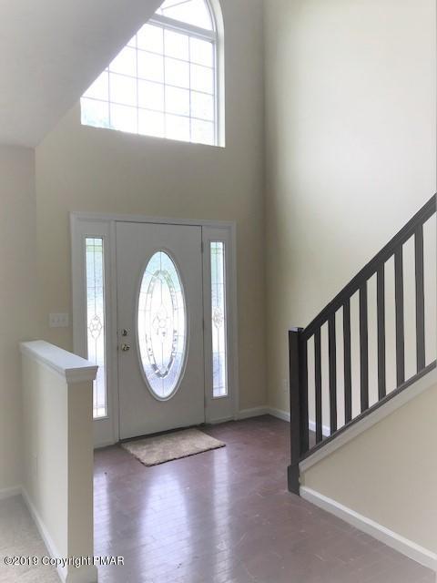6305 Laurel Road Pocono Summit, PA 18346 - Photo 2 of 13 an empty room with wooden floor and a window