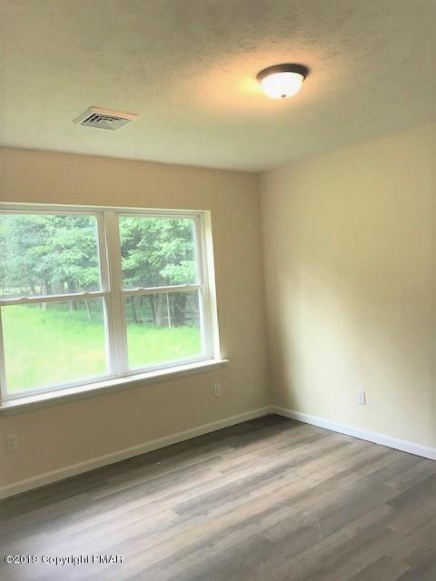 6305 Laurel Road Pocono Summit, PA 18346 - Photo 6 of 13 a view of an empty room with a window