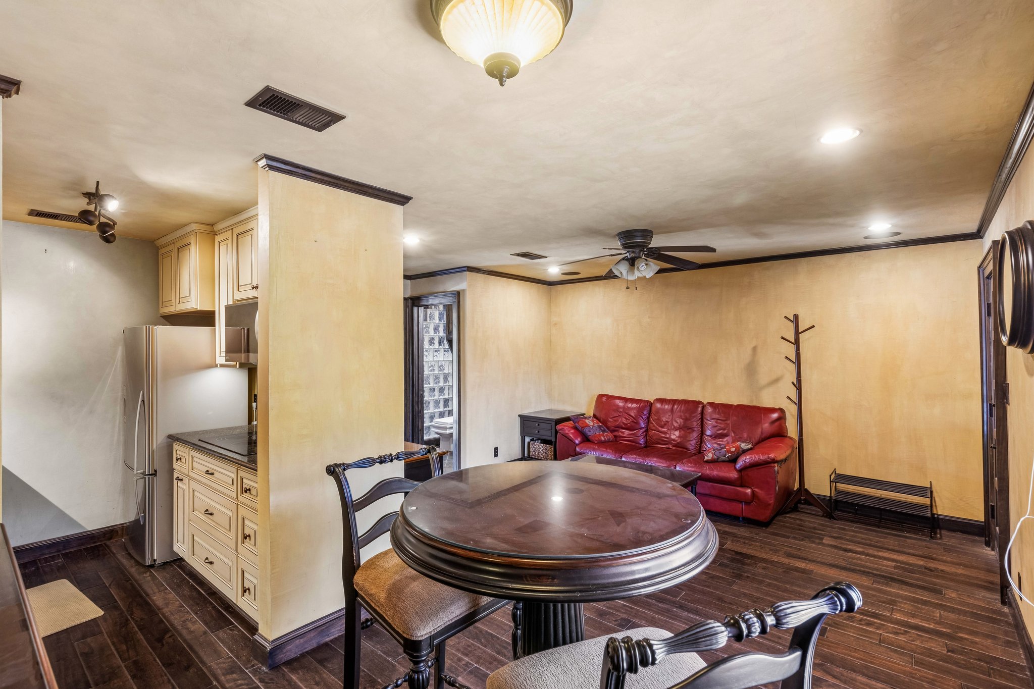 500 East Riverside Drive, Unit 254 Austin, TX 78704 - Photo 3 of 10 An inviting open-concept area featuring rich wood flooring and a functional kitchenette, ideal for casual living and entertaining.