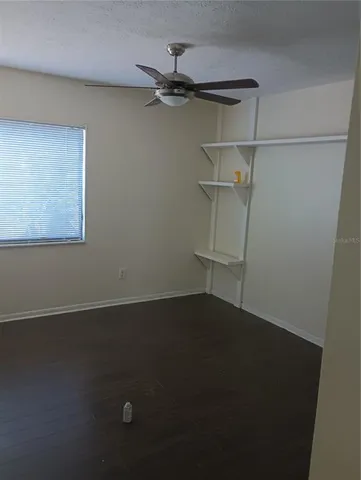 an empty room with a wooden floor and a window