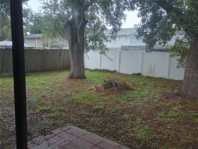 a view of a house with a yard and tree