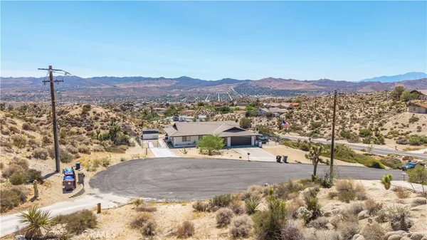 a view of a large building with mountains in the background