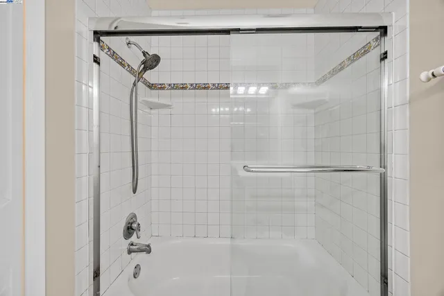 a bathroom with a shower and a glass door