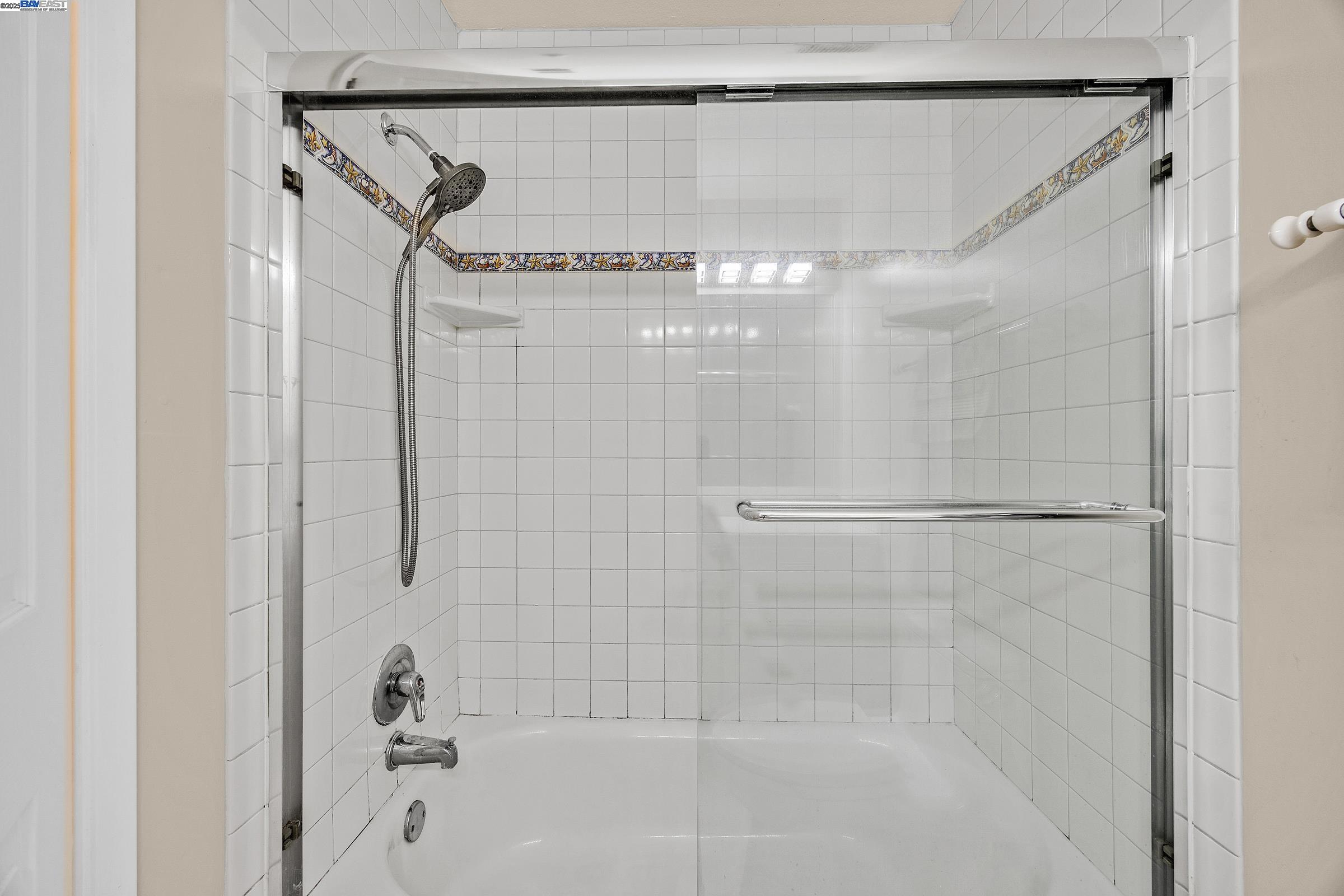 1308 Walden Road, Unit 37 Walnut Creek, CA 94597 - Photo 18 of 27 a bathroom with a shower and a glass door
