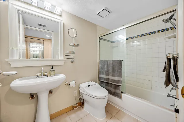 a bathroom with a sink toilet tub and shower