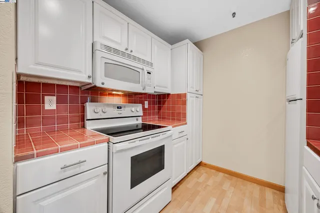 a kitchen with appliances and cabinets