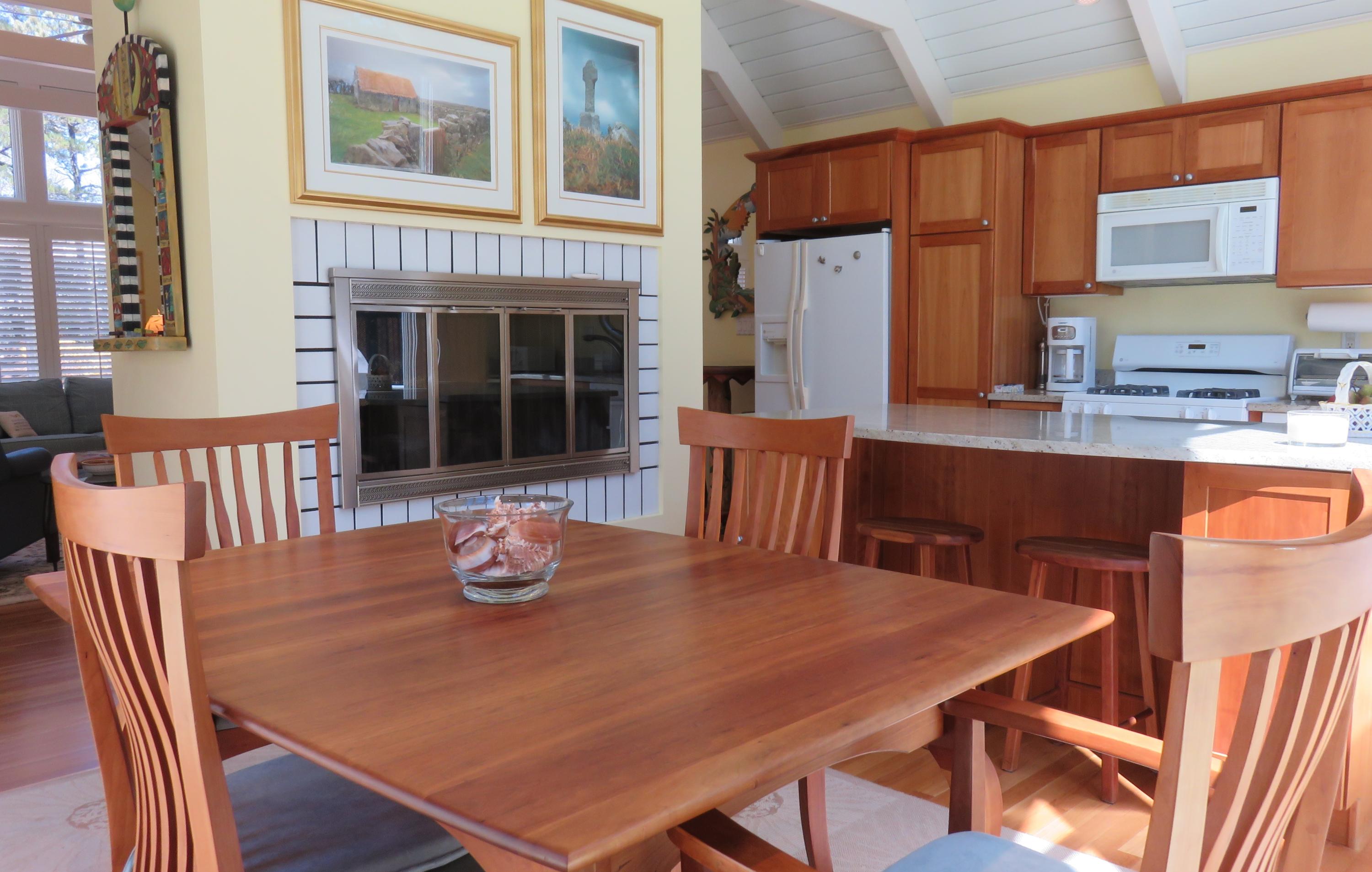 30 Greensward Road Mashpee, MA 02649 - Photo 10 of 33 a dinning table and chairs in a open kitchen