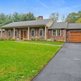 a front view of house with yard barbeque and outdoor seating