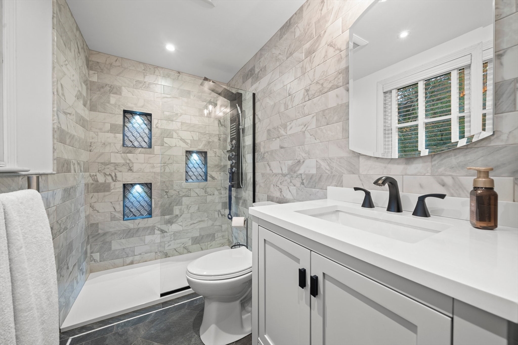 18 Sunnybrook Lane Canton, MA 02021 - Photo 21 of 40 a bathroom with a granite countertop sink toilet and shower