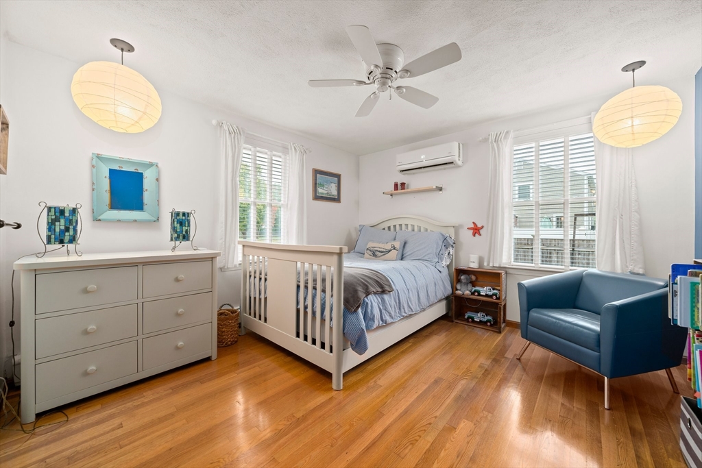 18 Sunnybrook Lane Canton, MA 02021 - Photo 22 of 40 a bedroom with a bed and a chandelier