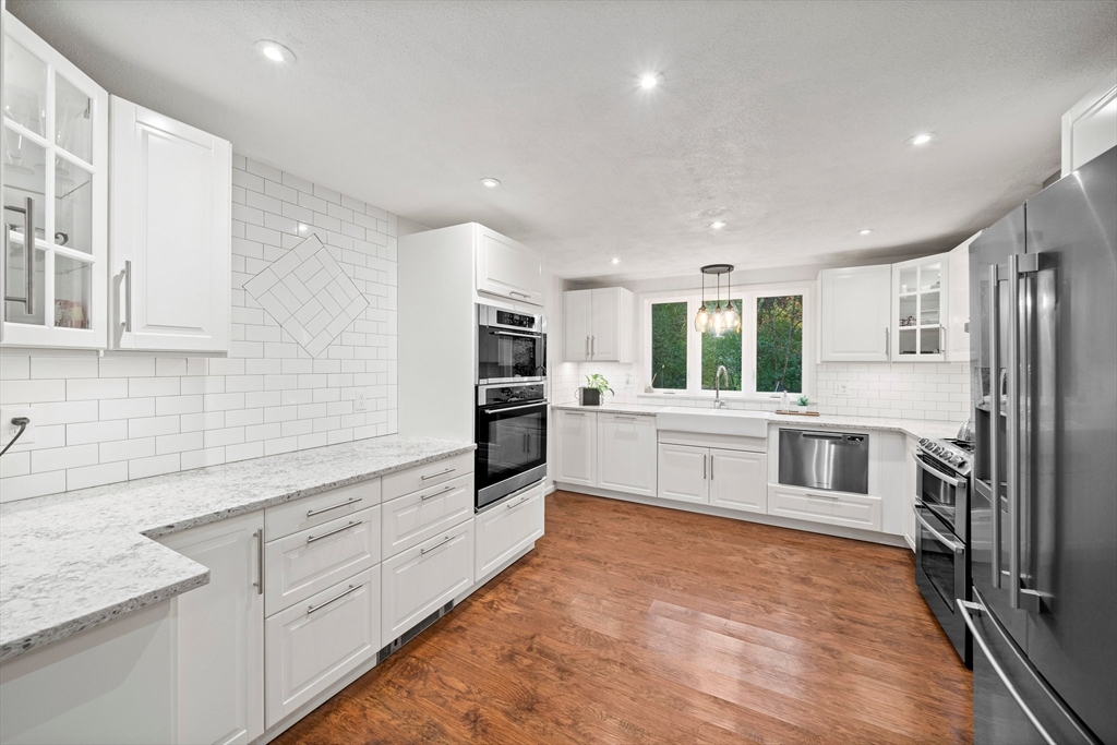 18 Sunnybrook Lane Canton, MA 02021 - Photo 5 of 40 a white kitchen with stainless steel appliances