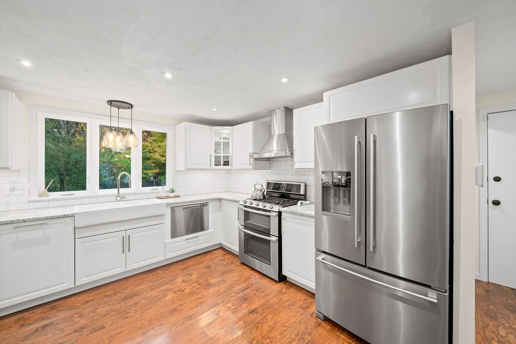 18 Sunnybrook Lane Canton, MA 02021 - Photo 6 of 40 a kitchen with a refrigerator a sink and a stove top oven