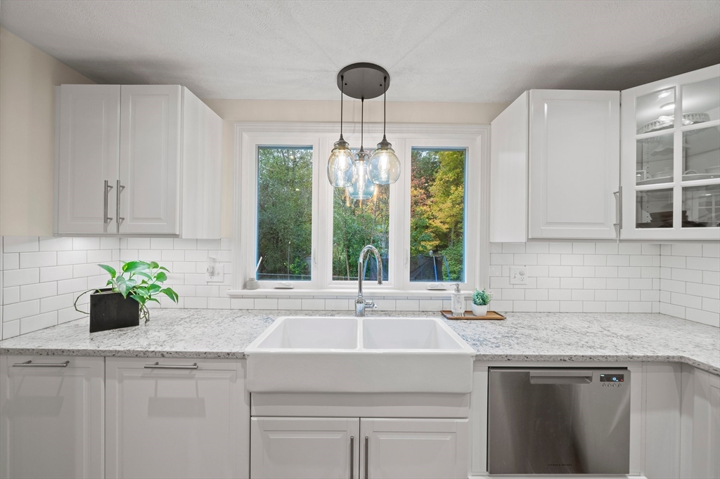 18 Sunnybrook Lane Canton, MA 02021 - Photo 7 of 40 a kitchen with stainless steel appliances a sink a large window and a counter space
