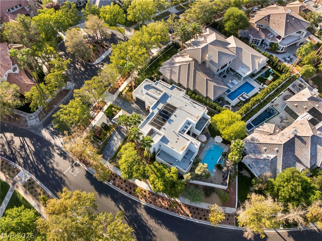 2000 Grouse Street Las Vegas, NV 89134 - Photo 85 of 89 An aerial perspective reveals a luxurious neighborhood with private pools nestled amongst lush landscaping and modern residences.