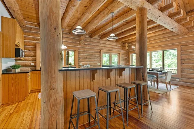 a view of a livingroom with a hall and wooden floor