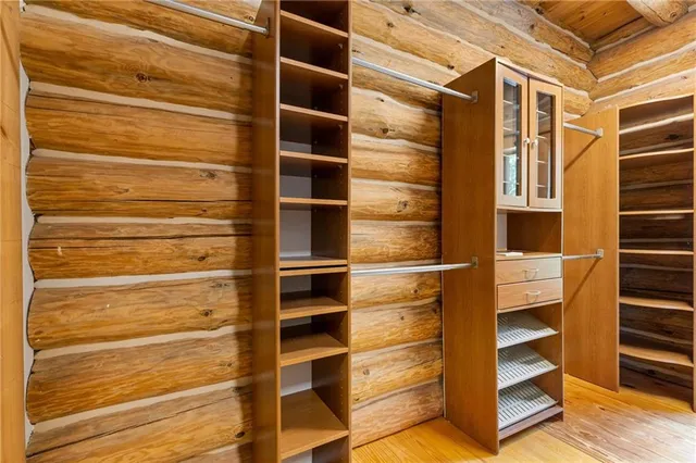 an aerial view of a house with a yard and a large tree