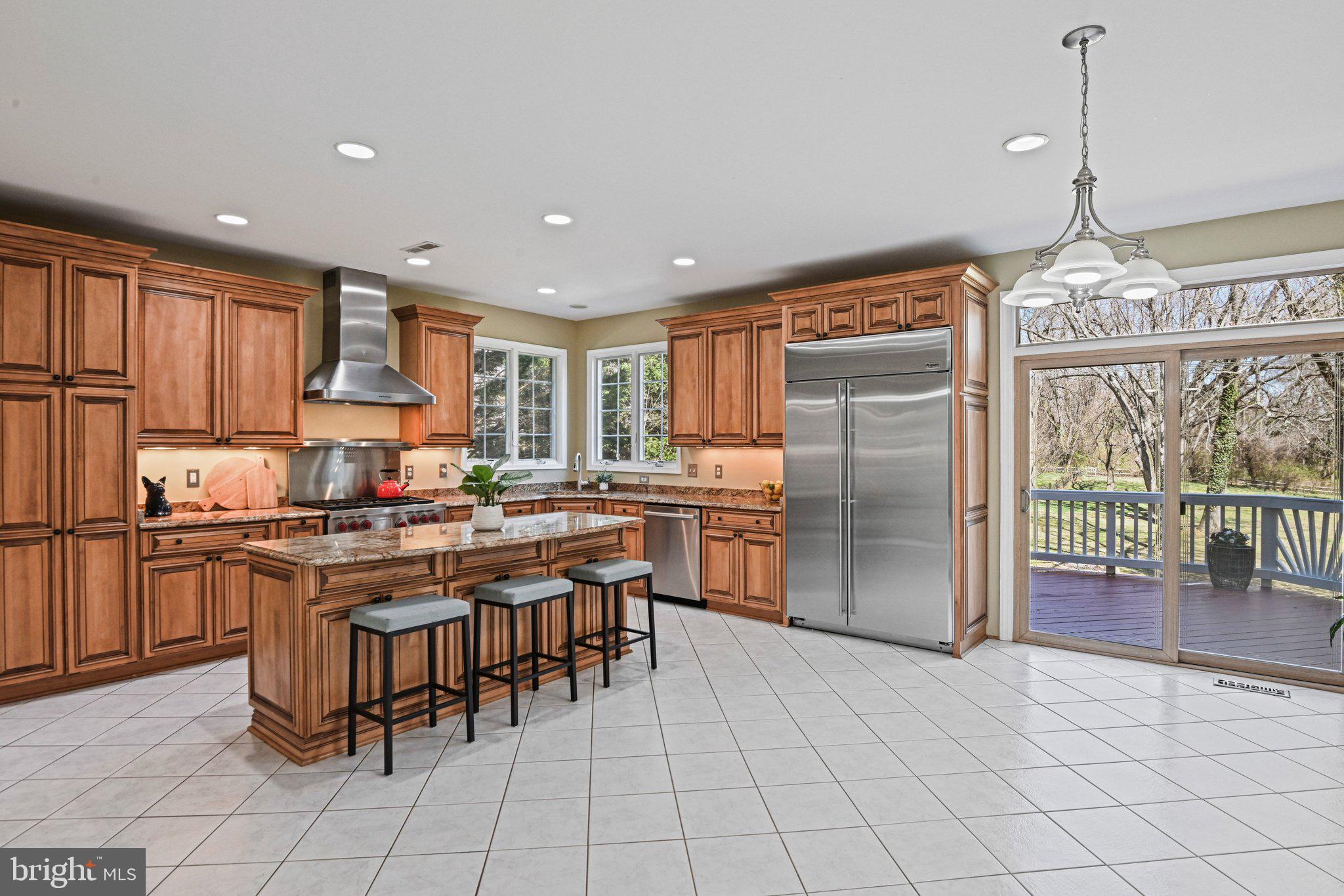 1831 Beulah Road Vienna, VA 22182 - Photo 15 of 96 a kitchen with stainless steel appliances granite countertop a stove top oven a refrigerator a sink and a dining table