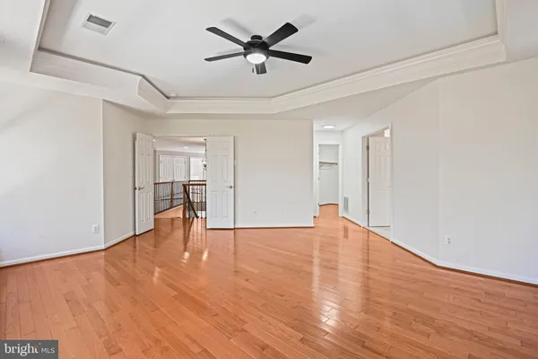 a view of a livingroom with wooden floor and window