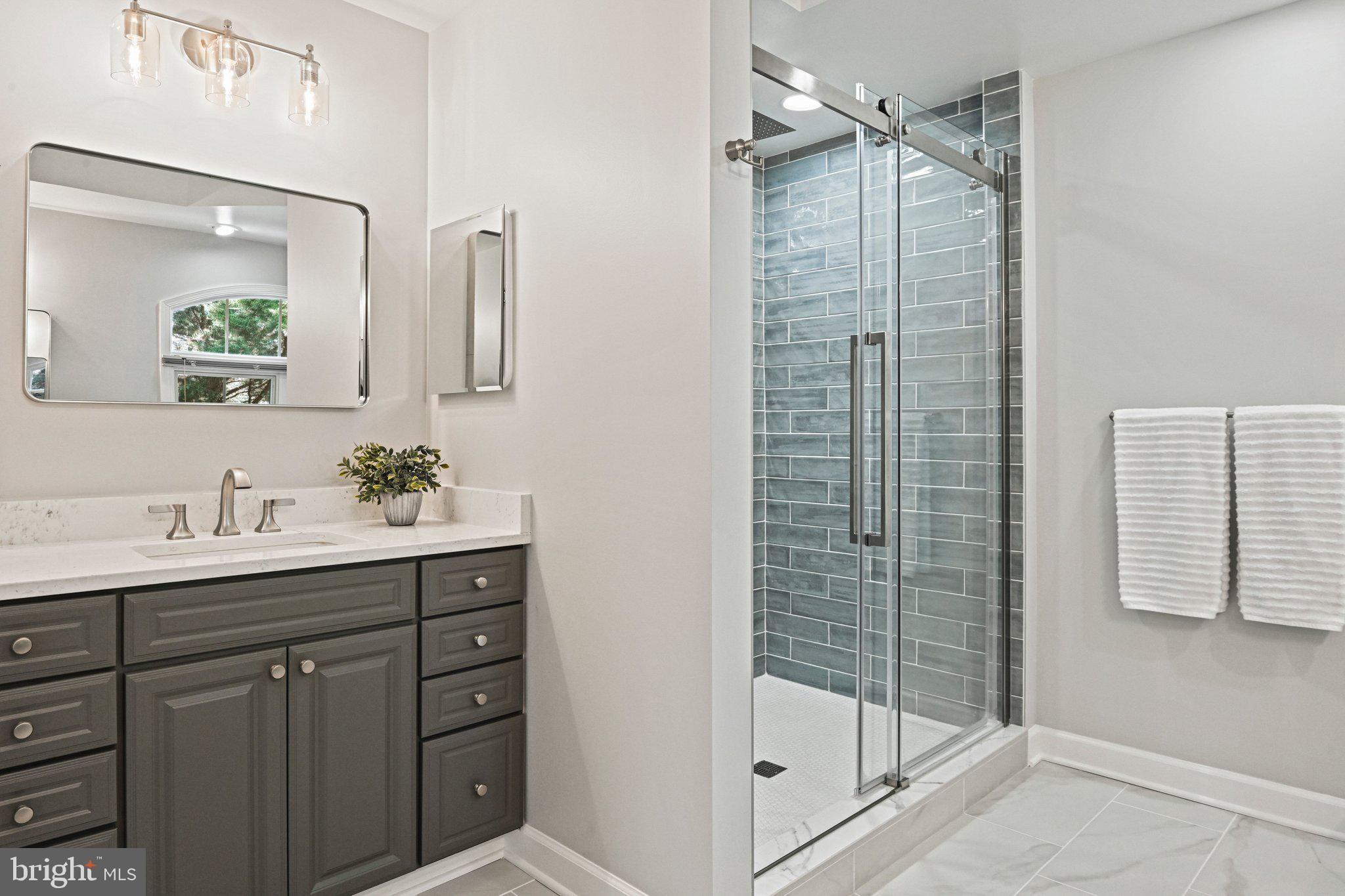1831 Beulah Road Vienna, VA 22182 - Photo 33 of 96 a bathroom with a shower sink and mirror