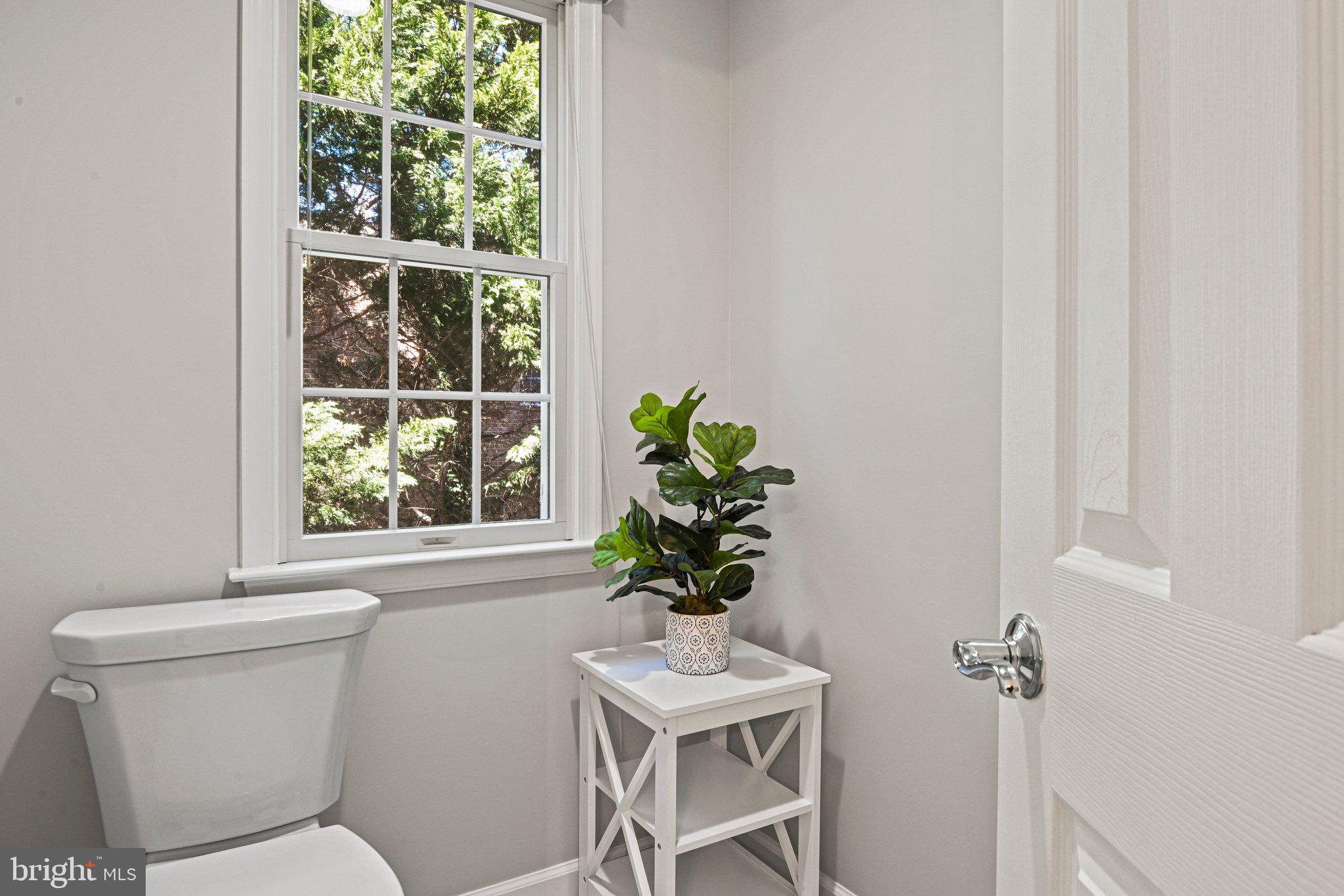 1831 Beulah Road Vienna, VA 22182 - Photo 36 of 96 a bathroom with a toilet a sink and a window