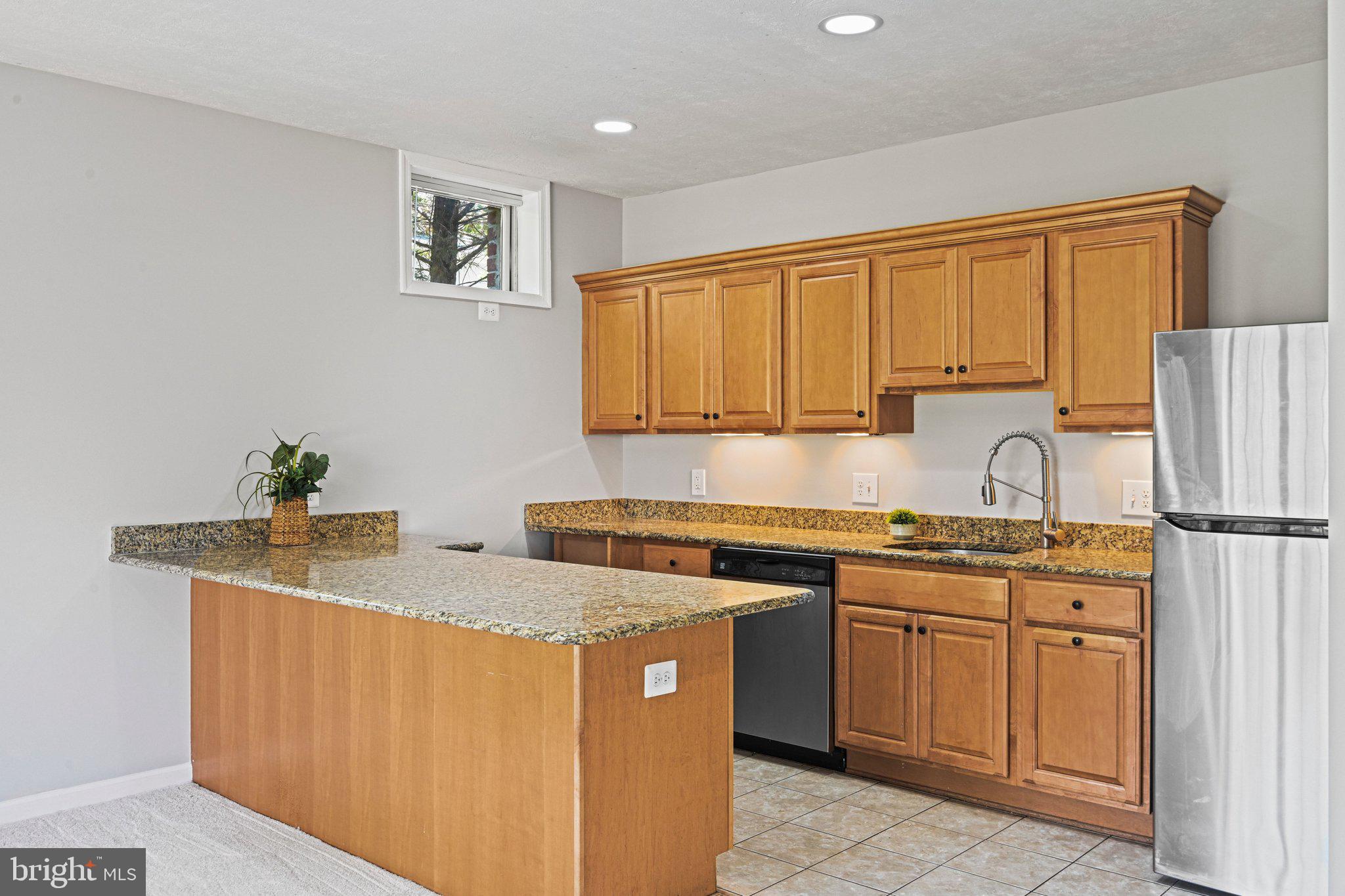 1831 Beulah Road Vienna, VA 22182 - Photo 59 of 96 a kitchen with stainless steel appliances granite countertop a sink stove and refrigerator