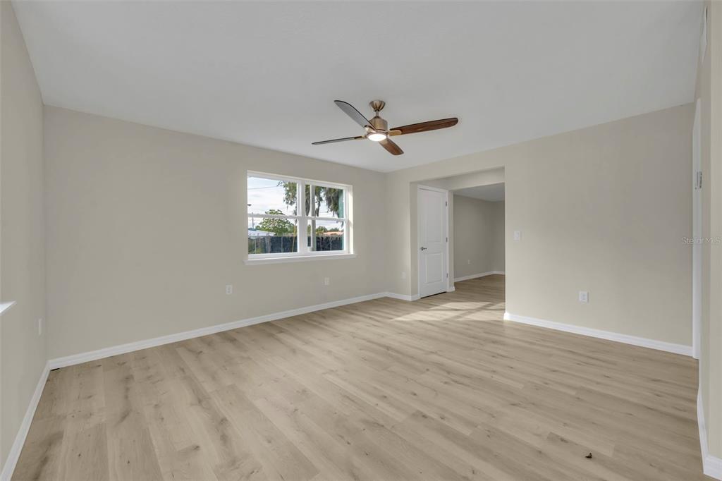 31201 Merry Road Tavares, FL 32778 - Photo 5 of 40 a view of an empty room with a window and wooden floor