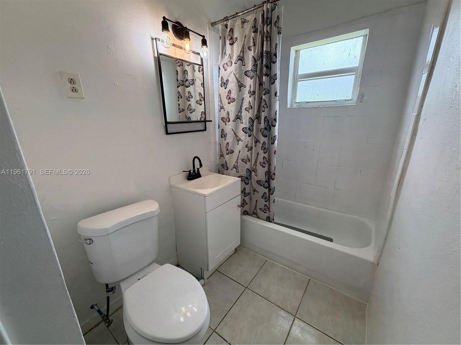 11700 Southwest 221st Street Miami, FL 33170 - Photo 7 of 10 a white toilet sitting next to a bathroom sink