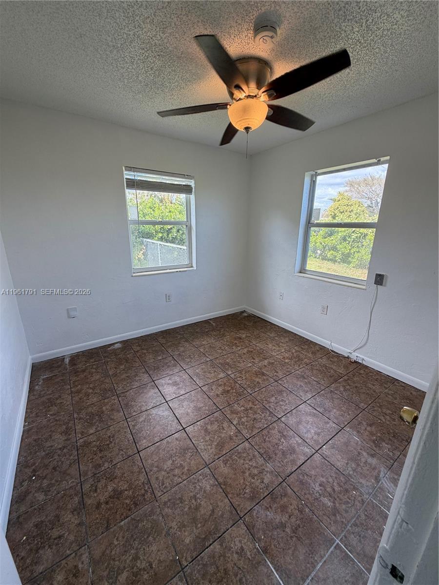 11700 Southwest 221st Street Miami, FL 33170 - Photo 8 of 10 an empty room with windows