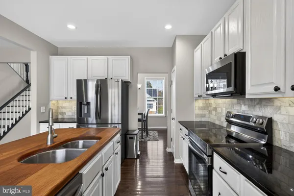 a living room with furniture a flat screen tv and a large window
