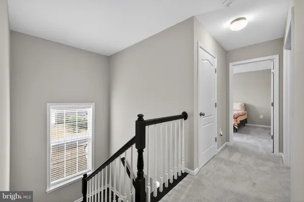a spacious bedroom with a bed and a chandelier