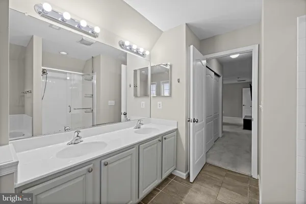 a bathroom with a glass shower door