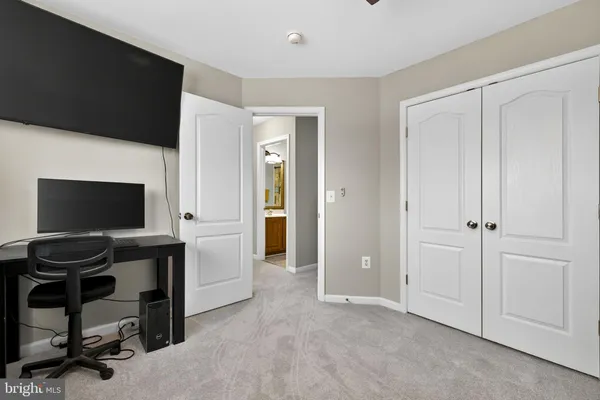 a bathroom with a sink vanity mirror and toilet