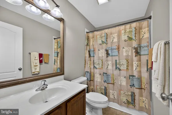 a view of a room with wooden floor and entryway