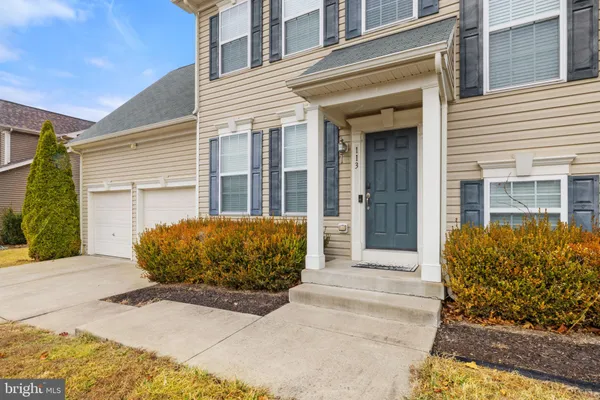 a view of a brick house with large windows
