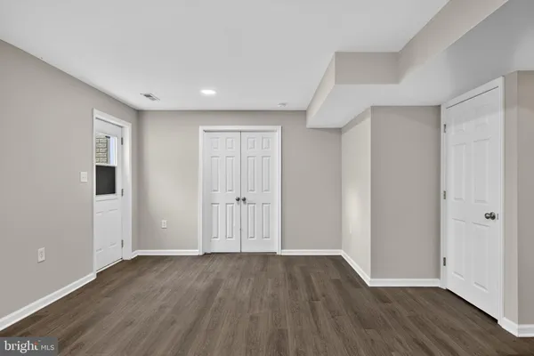 a view of a room with wooden floor and a toilet
