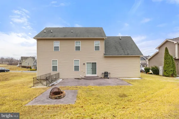 a view of a house with backyard and sitting area