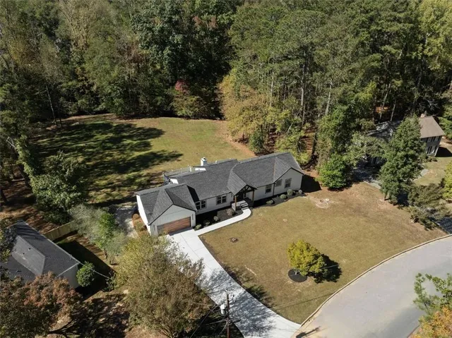 an aerial view of a house with a yard