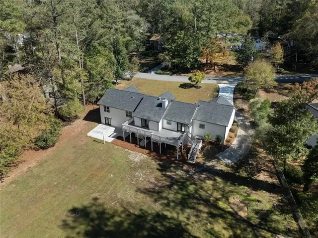 an aerial view of a house with yard