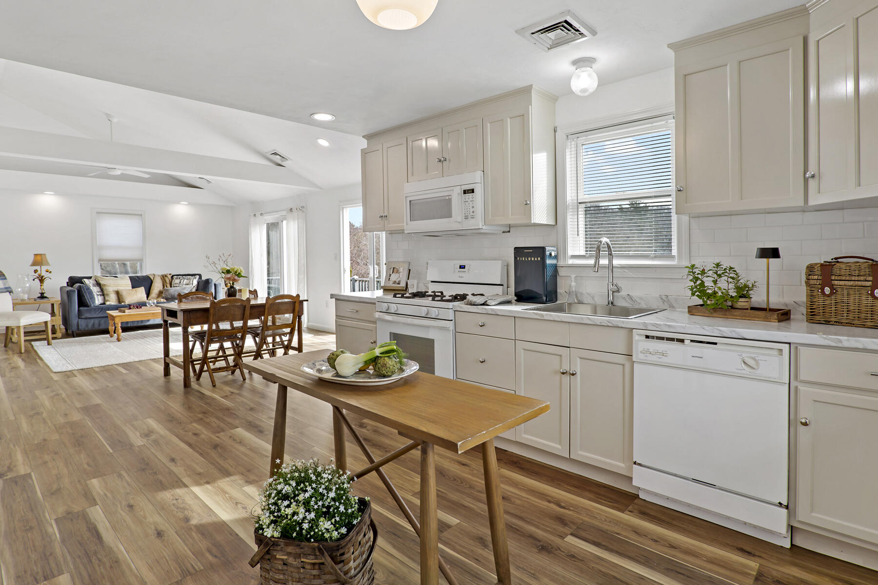 20 Evergreen Street Onset, MA 02558 - Photo 5 of 26 a kitchen with stainless steel appliances kitchen island granite countertop a table chairs sink and cabinets